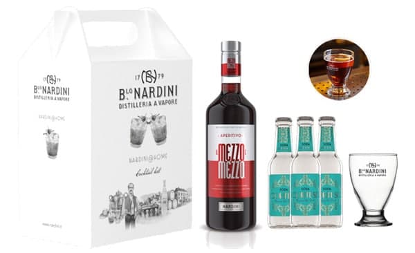 Gable top box with aperitif ingredients and a glass for cocktails