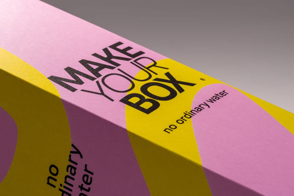 Side view of a pink and yellow box with natural white material